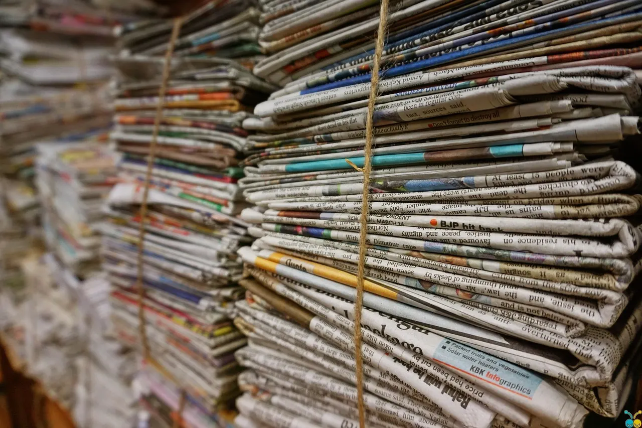 Bundles of yellowed old newspapers tied with twine