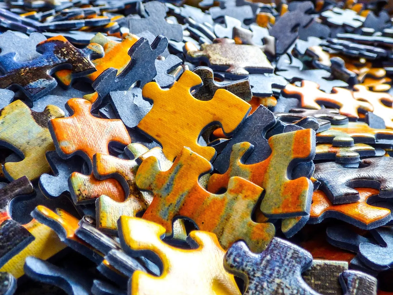 A loose heap of jigsaw pieces waiting to be sorted